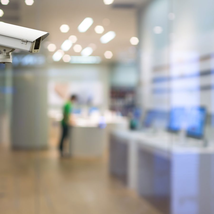 CCTV security camera on monitor the abstract store blurred in hall with bokeh background CCTV security camera on monitor the abstract store blurred in hall with bokeh background