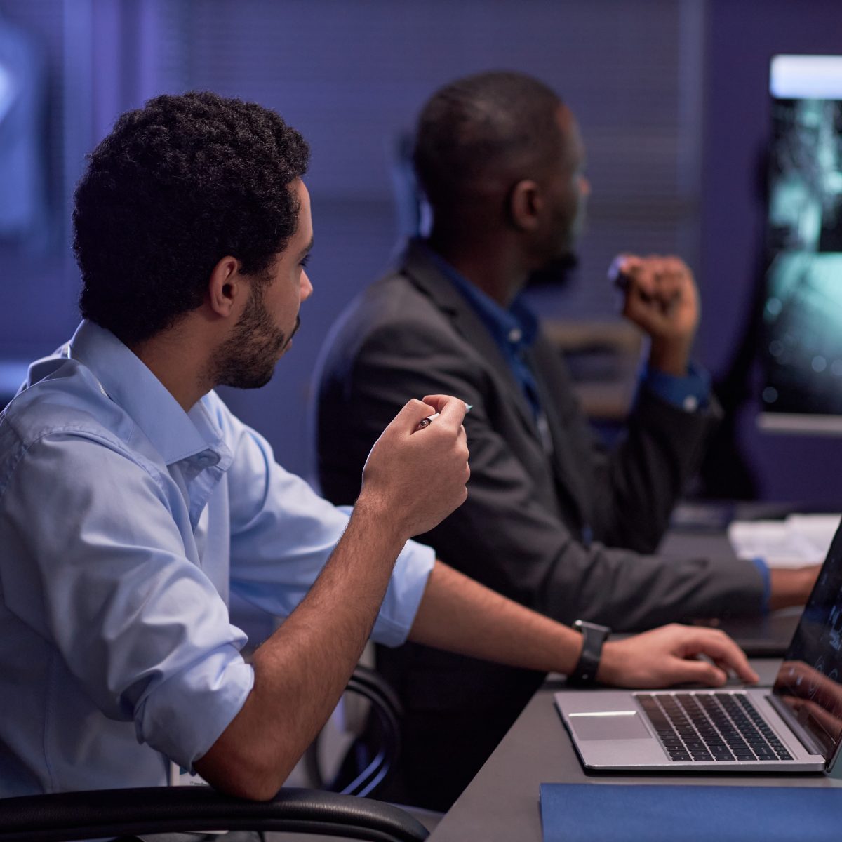 Two men looking at screen during meeting in IT security office Two men looking at screen during meeting in IT security office